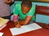 Signing the visitors books at Kamenu primary school where sanitary towels were donated